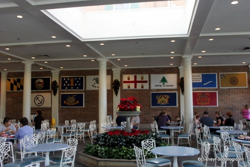 Indoor seating and colonial flags at Liberty Inn