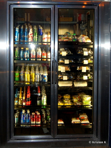 Fridge Full of Snacks and Drinks Behind the Bar